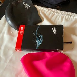 Two caps and swim trunks